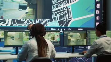 Diverse call center operators monitoring couriers in traffic and update clients on potential order delay due to busy routes. Employees guiding the delivery cars via gps and satellite map. Camera A. photo