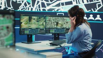 Woman call center operator guiding delivery truck drivers on different routes to avoid traffic and help with express shipment. Agency uses surveillance CCTV and gps tracking. Camera A. photo