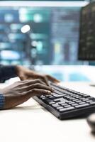 Governmental hackers at work monitoring cyber threats in high tech agency, implementing cybersecurity measures. IT expert focuses the importance of online privacy and malware protection. photo