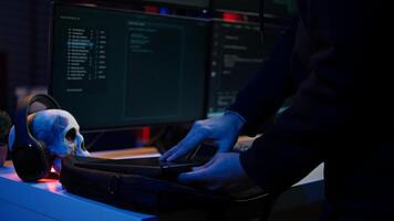 Hacker taking laptop out of suitcase, prepared to launch DDoS attack. Cybercriminal entering apartment, getting notebook from bag, starting work on malware script, close up, camera B photo