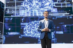 Portrait of jolly presenter speaking at tech conference, exploring latest AI technology trends and case studies. Joyous IT engineer presenting artificial intelligence products during event photo
