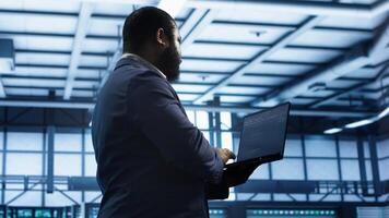 Technician in data center workspace running system diagnostic tests and error checking utilities to fix issues. Employee looks for network issues affecting rigs performance and connectivity, camera A photo