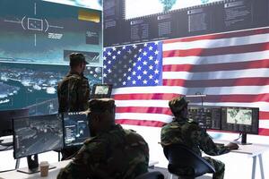 US soldiers operating in a high tech cybersecurity command post, managing state secrets and classified information. Protecting the national servers against digital threats and cyber warfare. photo