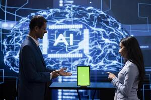 Engineer and supervisor use AI machine learning to extract information from complex data on isolated screen tablet. Experts in workspace use artificial intelligence technology on chroma key device photo
