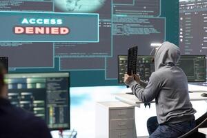 Displeased irritated team of hackers with denied access message on a big screen in governmental operations agency. Experts struggling to break into databases and steal server information. photo
