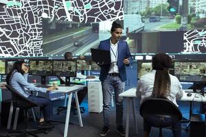 Indian supervisor handles express delivery orders through city traffic, working with his team to provide alternative routes via satellite navigation and CCTV footage. Gps tracking system. photo