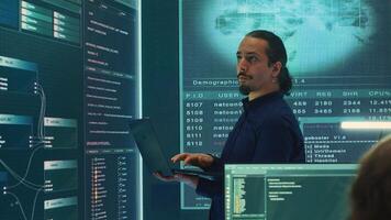 Governmental hacker expert working on securing digital information, analyzes intelligence on big screen. Specialist works to prevent cyber threats with advanced technology, cyberterrorism. Camera A. photo