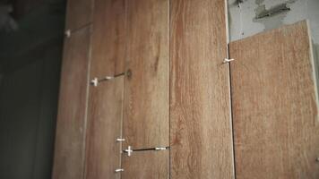 Worker installs ceramic tiles on the wall video