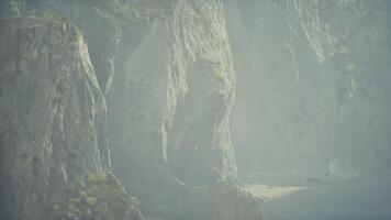 A misty mountain landscape with rocks and trees video