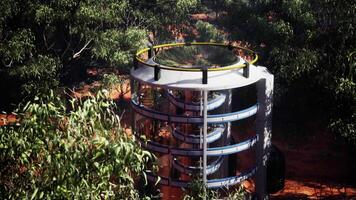 glass greenhouse with a round structure and surrounded by lush trees video