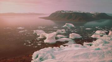 A serene landscape with floating icebergs in a tranquil body of water video