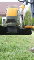 vertical close-up of a working grass string trimmer video
