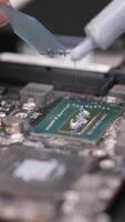 vertical close-up applying thermal paste to computer processor chip video