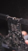 vertical Close-up of dust flying from a computer board video