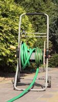 vertical Garden hose reel slowly rotating showing winding mechanism video