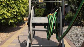 close-up Garden hose reel slowly rotating showing winding mechanism video