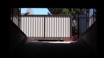 automatic gates on a remote control open before entering the courtyard video
