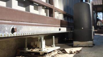 close-up of mechanism of closing metal automatic gate. Moving gears driving gate video