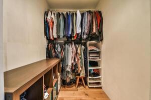 A closet with clothes and shoes on a shelf photo