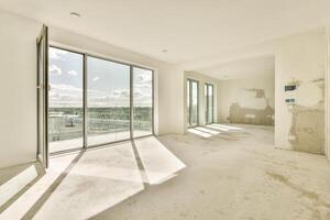 Empty room with large windows and white walls photo