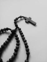 photo of a rosary cross made of wood in black and white monochrome