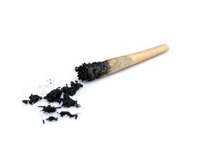 Burnt Pre Roll cigarette butts and ashes on isolated white background photo