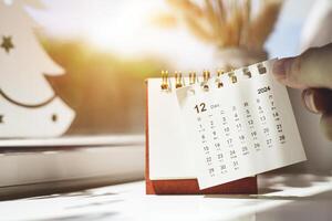Calendar page of December of 2024 torn off for change of year on table. with copy space and business design. Concepts for planning and setting new strategic goals photo