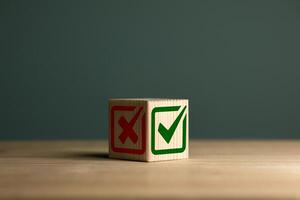 Green check mark and red cross icon on wooden cube. Right and wrong. Checklists, approval lists, and test concepts. photo