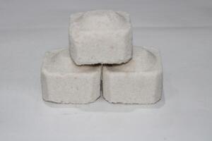 Three white square shaped objects stacked on a white background. photo