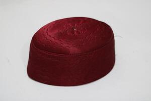 Red embroidered cap with a wave pattern isolated on white. photo