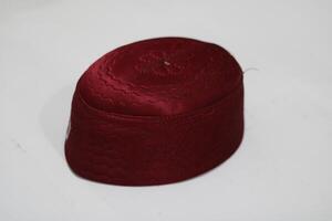 Close-up of a maroon hat with embroidered details. photo