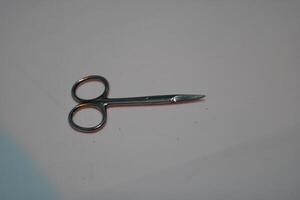 Silver scissors on a white background. photo