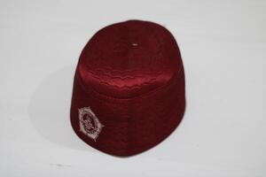 Red woven cap with a decorative design. photo