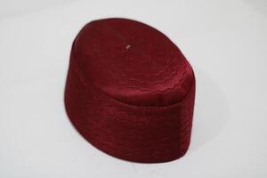 Maroon patterned cap with stitching detail. photo