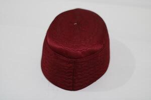A maroon cap with a quilted pattern. photo
