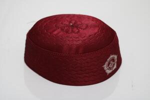 Red embroidered skullcap on white background. photo