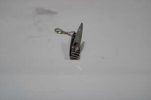 Silver nail clippers with chain on a white surface. photo