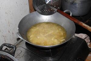Food being deep fried in a pan. photo