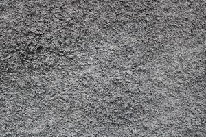 Close-up of rough, textured grey wall. photo