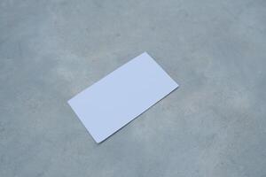 White blank card on a gray surface. photo