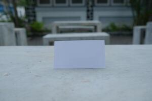 Blank white card on a concrete surface. photo