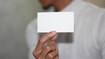 Hand holding blank white card, perfect for your message. photo
