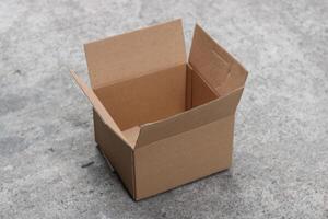 Empty cardboard box on a concrete surface. photo