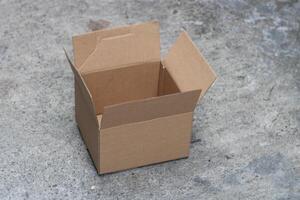 Empty cardboard box on a grey surface. photo
