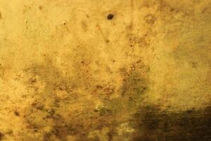 Abstract background with a textured, weathered, and golden surface. photo