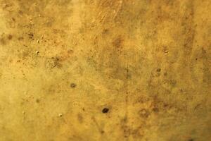 Close-up of a textured, weathered, yellow surface. photo