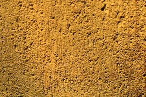 Close-up of a textured yellow wall. photo