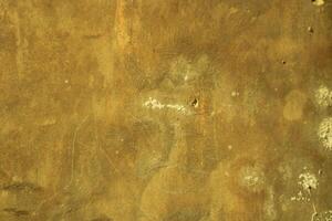Close-up of textured yellow wall with white blotches. photo