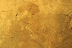 Rough, textured golden surface with subtle variations. photo