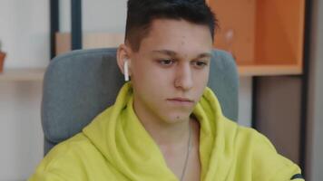The face of a student sitting in a room at the computer. Close up of a young student's face. video